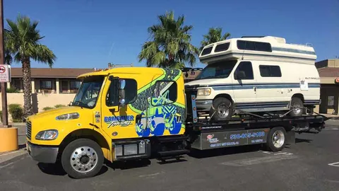 Bambauer Towing flatbed carrying a motor home in Orland, CA