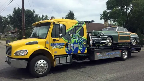 Bambauer Towing flatbed hauling a classic car in Orland, CA